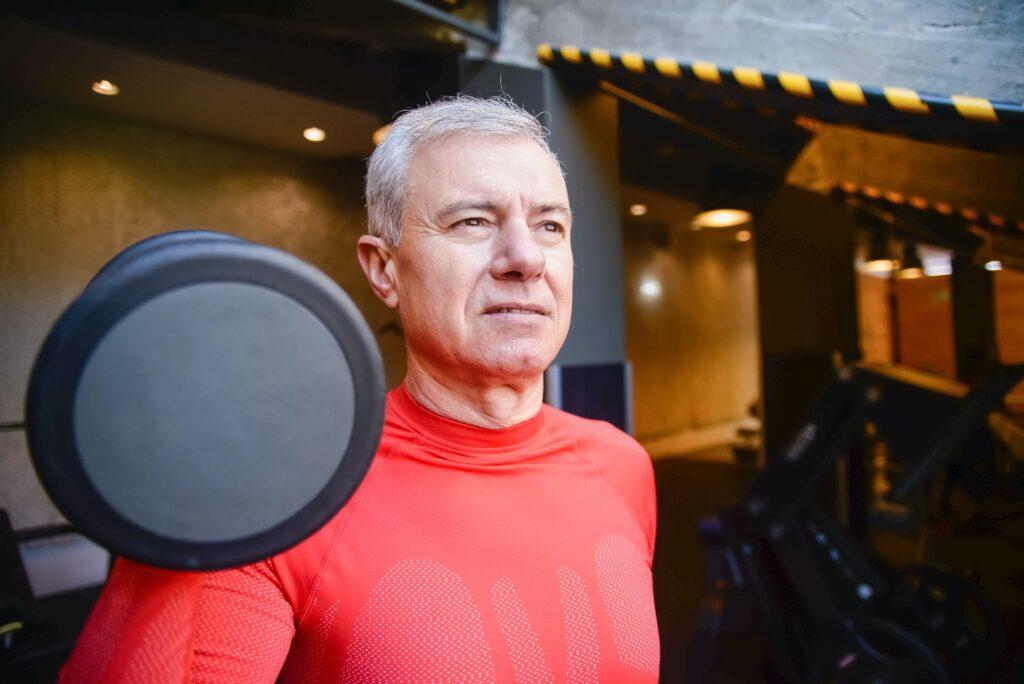 Elderly man working out with a dumbbell