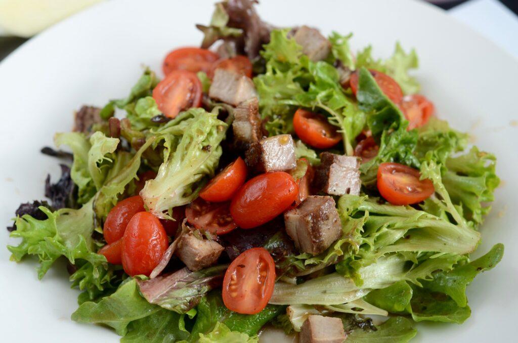 a greens salad with tomatoes