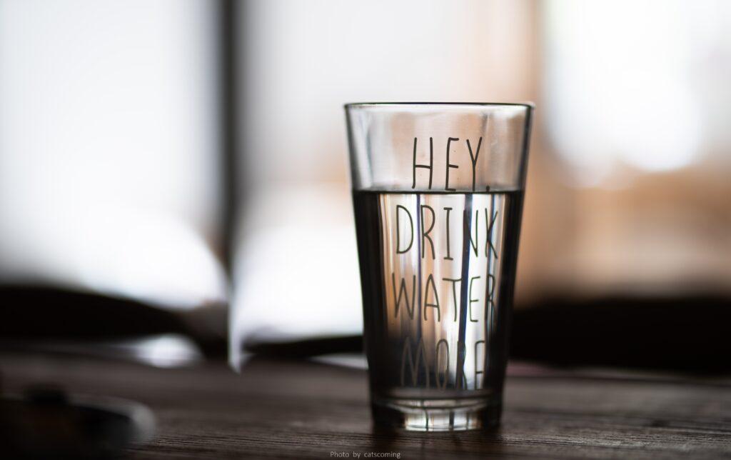 glass of water that says drink me water