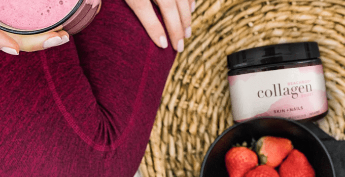 a picture of a woman sitting with a shake, collagen boost from Beachbody and strawberries