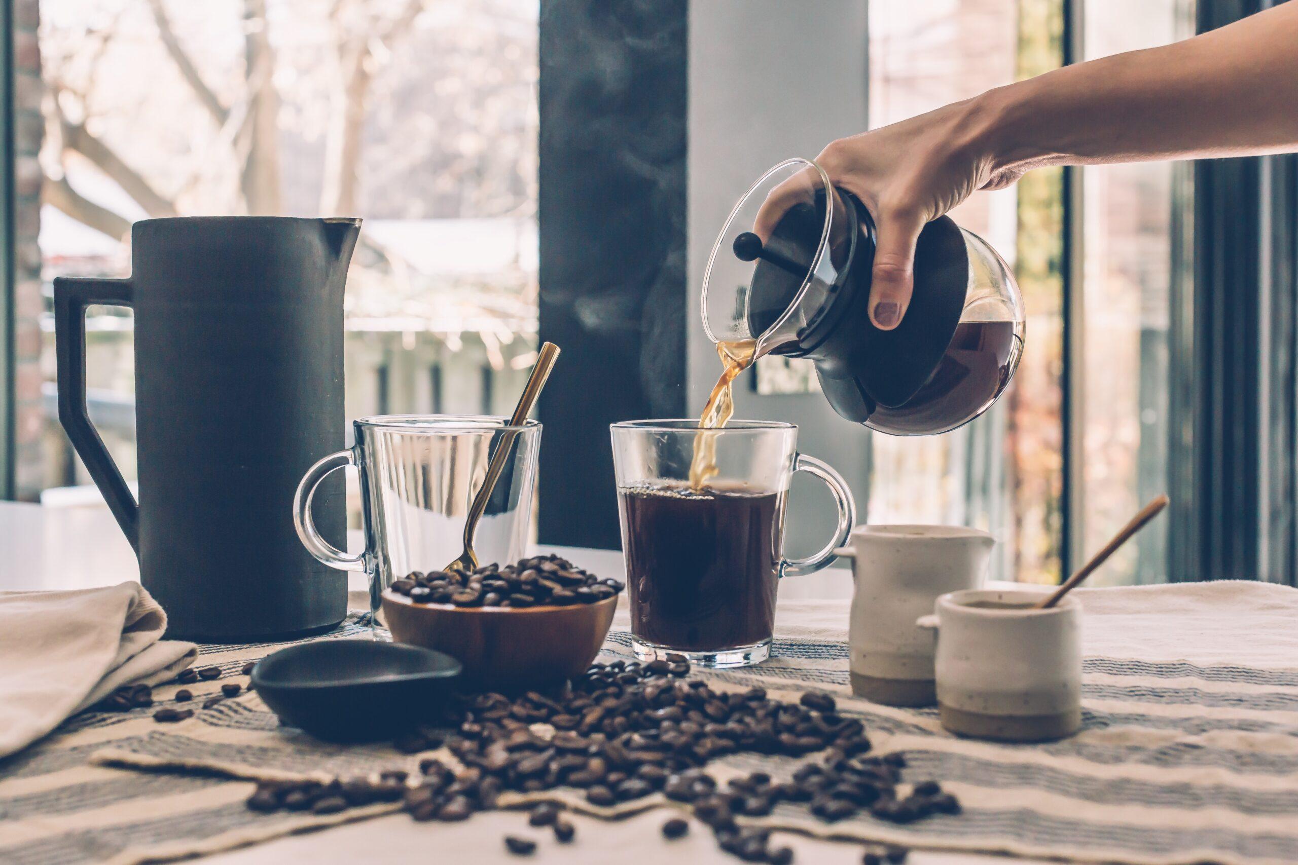 Picture of coffee beans and a person pouring a fresh cup of coffee